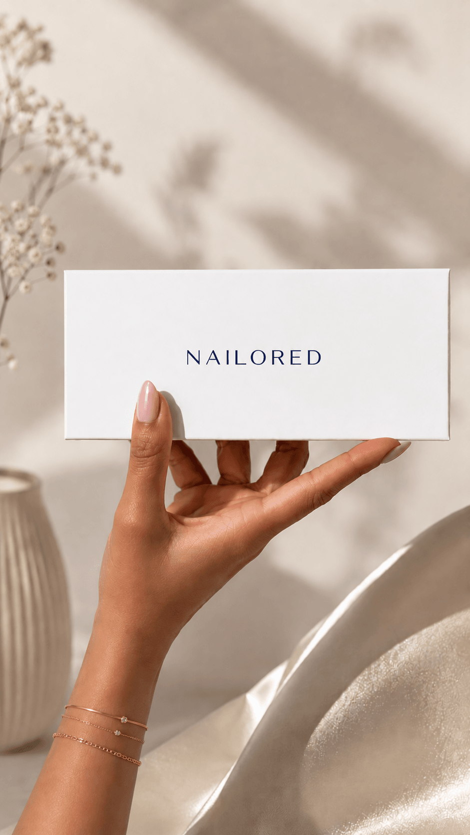 A hand wearing Nailored press-on nails in an almond French finish